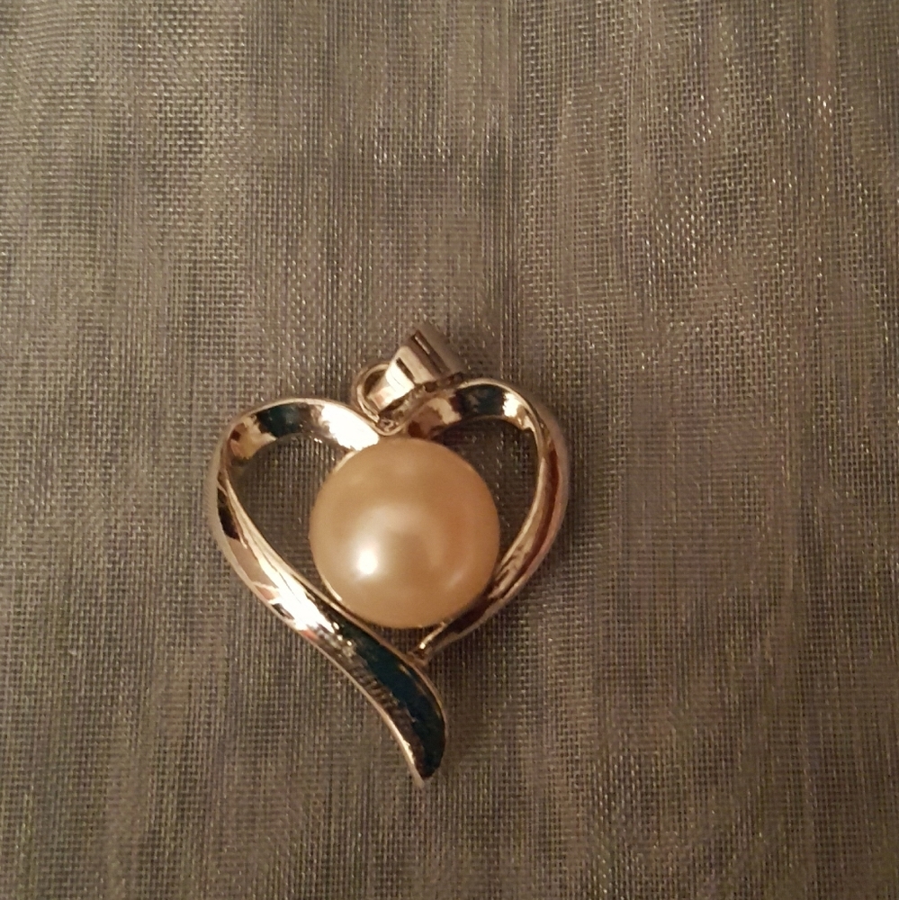 Heart shaped charm with pearl center.